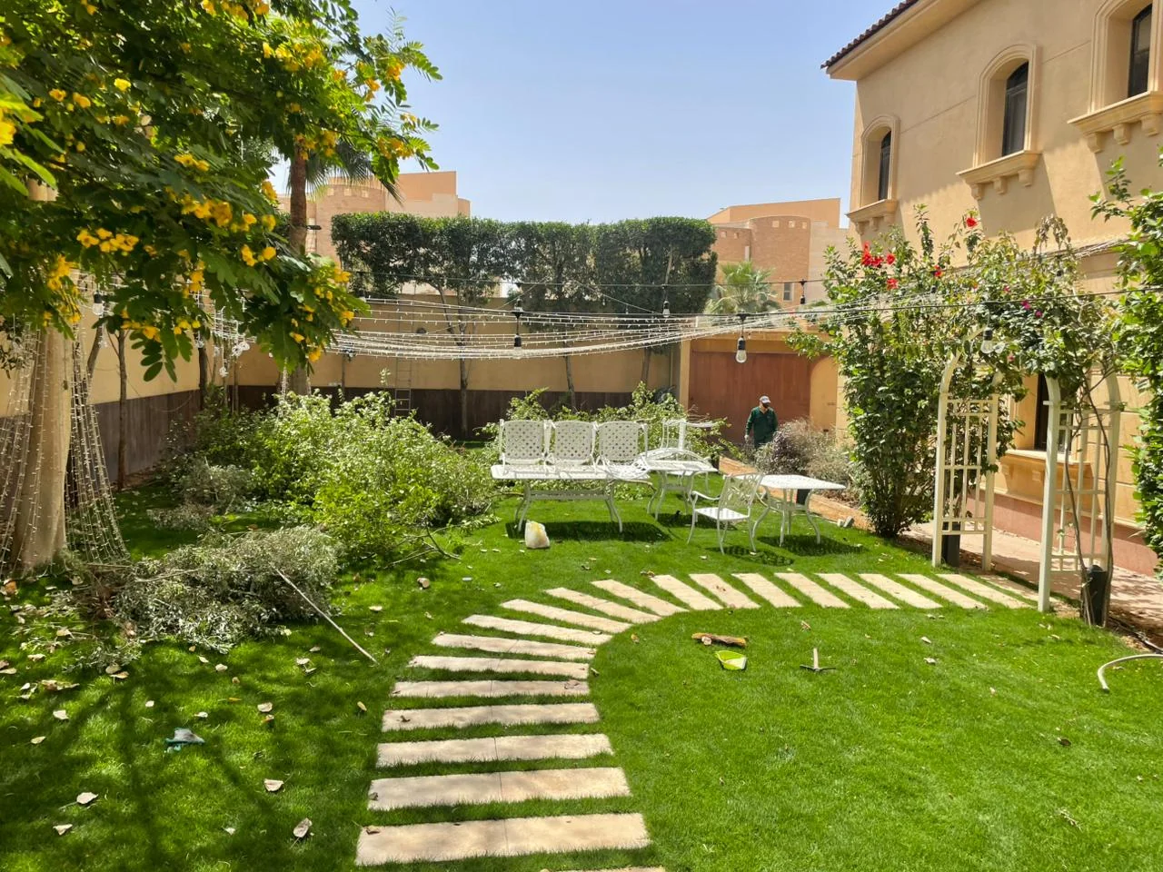 A finished Ghusn villa garden with a curved stepping-stone path