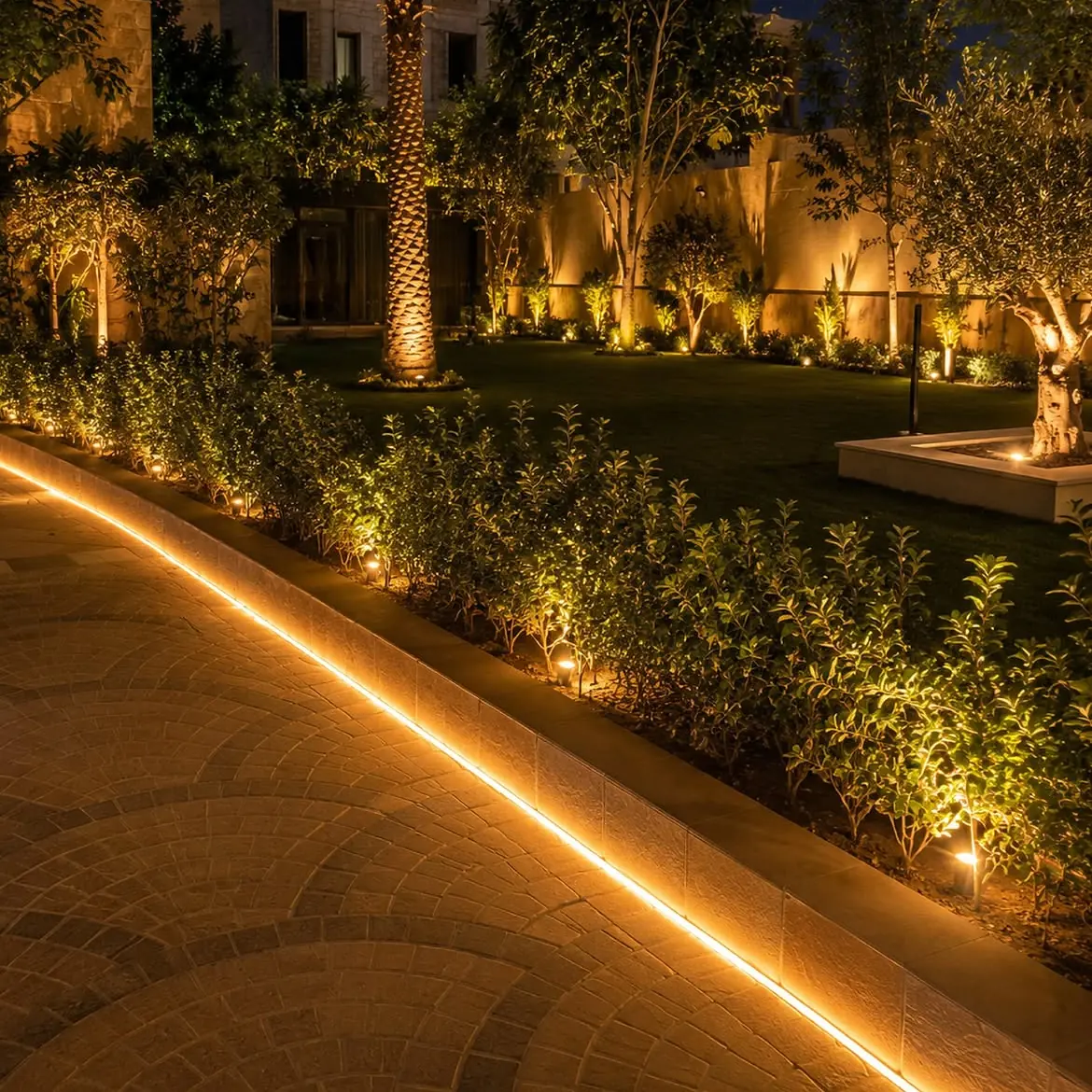 Curved LED edging along a planted border at night