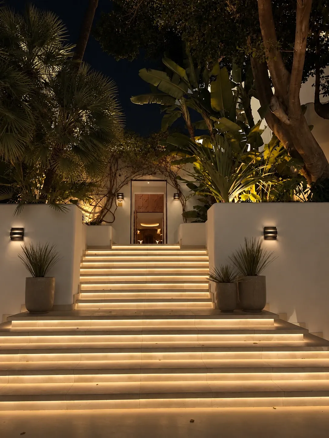 The same garden stairs lit at night